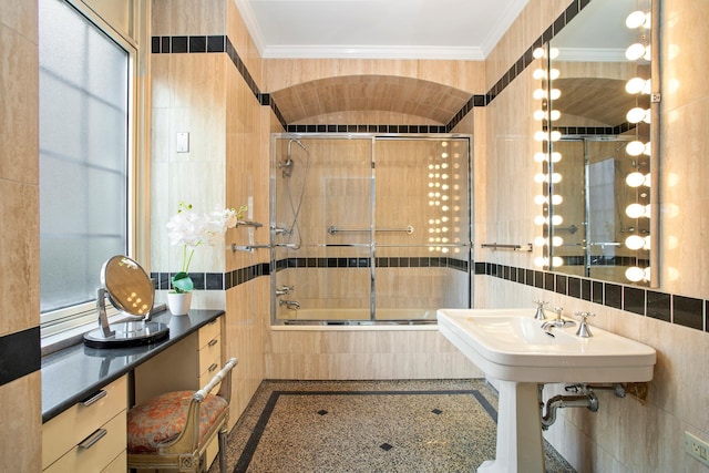 bathroom with tiled shower / bath, tile walls, and crown molding