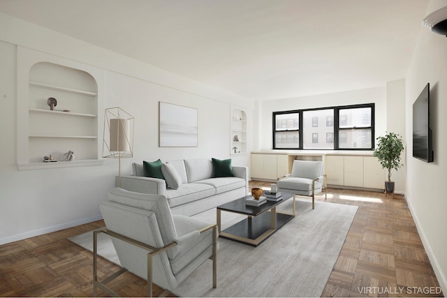 living area featuring built in shelves and baseboards