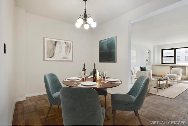 dining space featuring baseboards and a chandelier