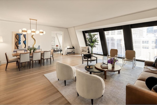 living room featuring an inviting chandelier and light hardwood / wood-style flooring