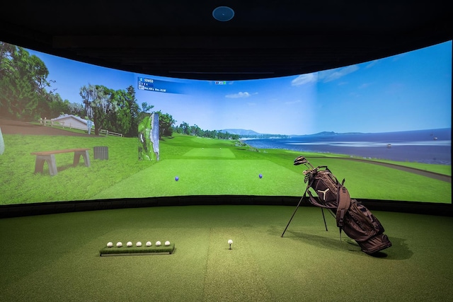 exterior space with golf simulator, carpet flooring, and baseboards