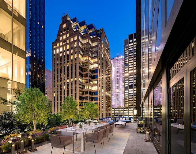 exterior space featuring an outdoor hangout area, a patio area, and a city view