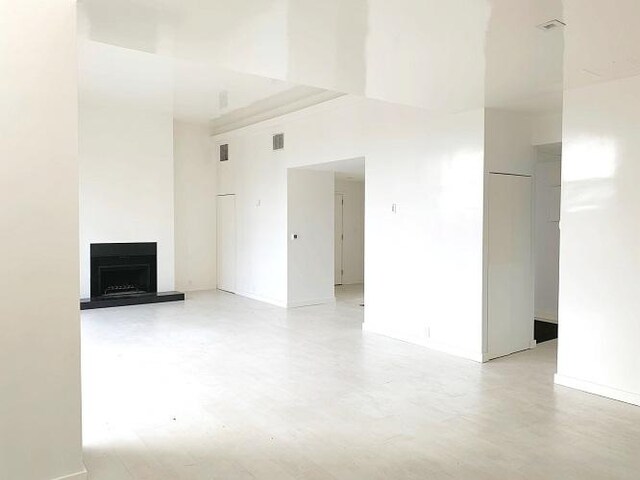 unfurnished living room featuring a high ceiling