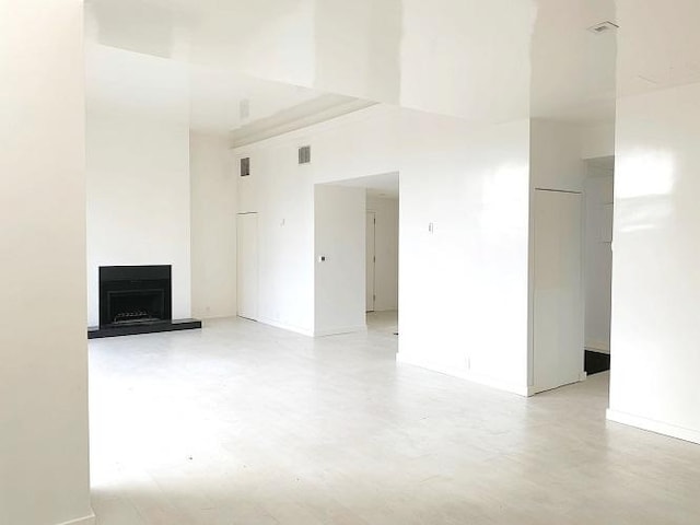 unfurnished living room with a towering ceiling