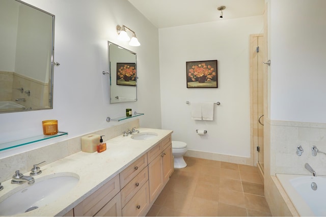 bathroom with tile patterned flooring, toilet, a tub to relax in, and a sink