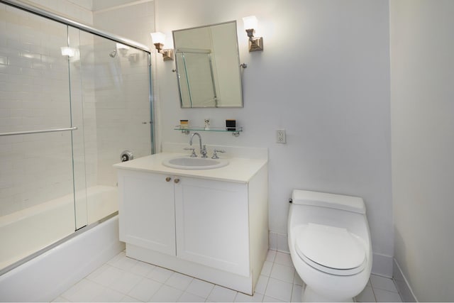 full bath featuring tile patterned floors, vanity, toilet, and bath / shower combo with glass door