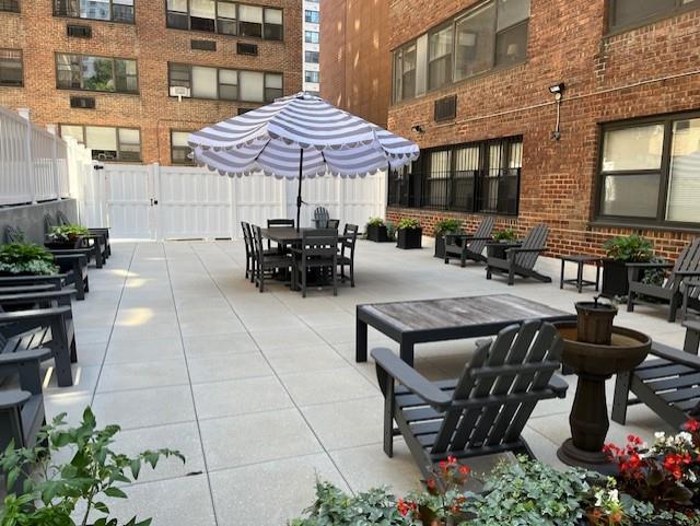 view of patio featuring outdoor dining area and fence