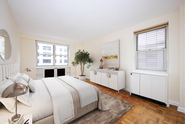 bedroom with multiple windows and baseboards