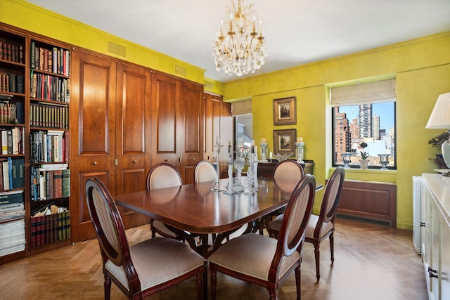 dining room featuring visible vents and a notable chandelier