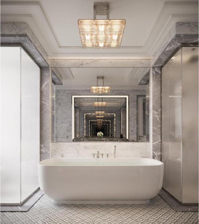 bathroom with a tub and a notable chandelier