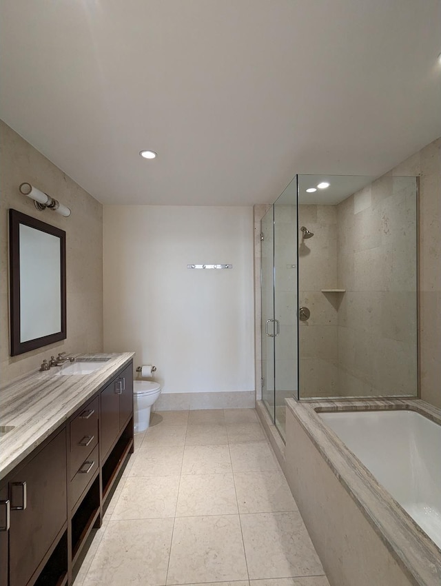 full bathroom featuring toilet, a stall shower, vanity, baseboards, and a bath