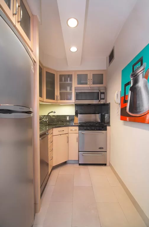 kitchen featuring light tile patterned floors, appliances with stainless steel finishes, and sink