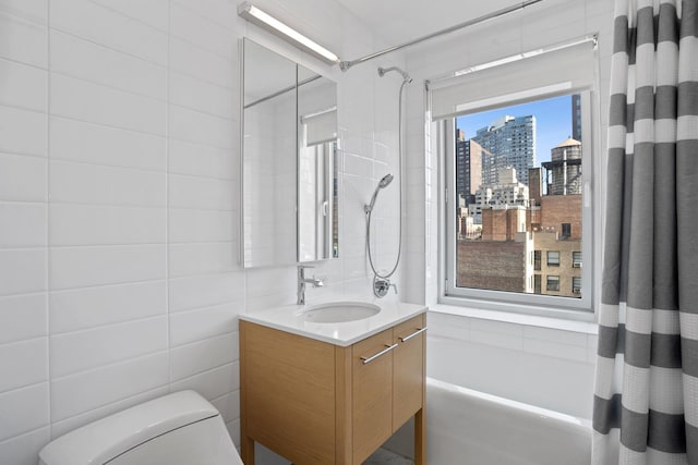 bathroom with a city view, toilet, vanity, tile walls, and shower / bathtub combination with curtain