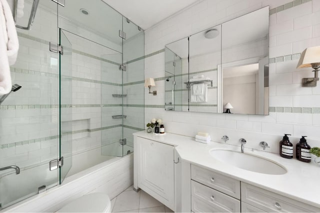 full bathroom with enclosed tub / shower combo, tile patterned flooring, vanity, tasteful backsplash, and tile walls