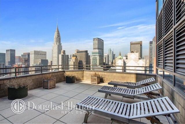 240 E 47th St Unit 33C, New York City, NY 10017 - view of patio with a skyline view and a balcony
