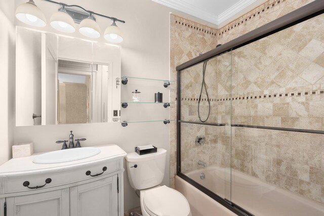 240 E 47th St Unit 33C, New York City, NY 10017 - full bath with ornamental molding, bath / shower combo with glass door, vanity, and toilet