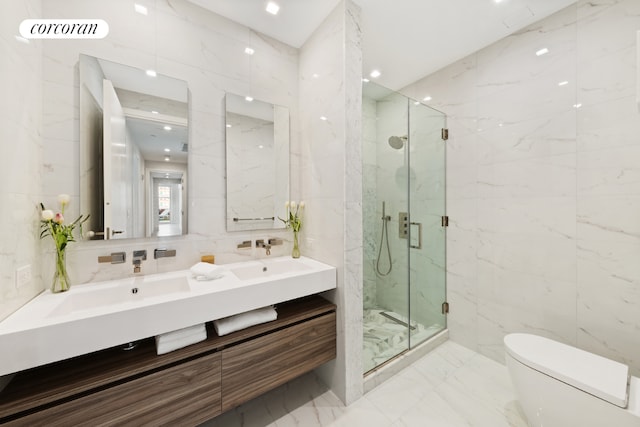 bathroom with tile walls, toilet, a shower with door, and vanity