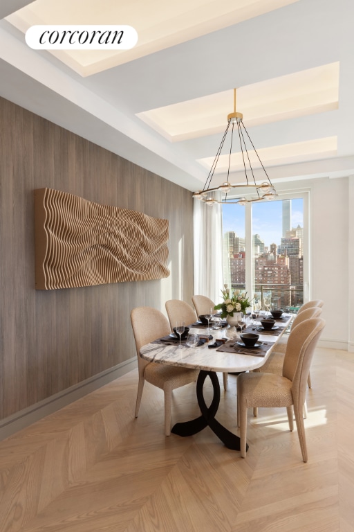 dining room with light parquet floors and wooden walls