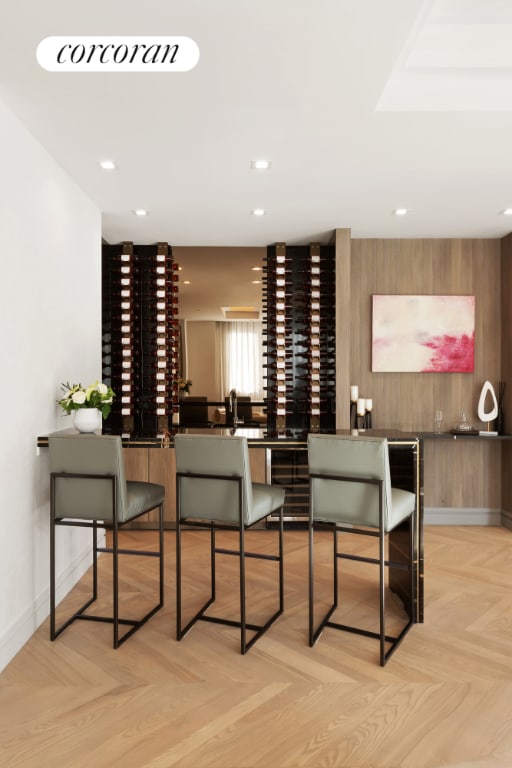 wine area with wine cooler, light parquet flooring, and wooden walls