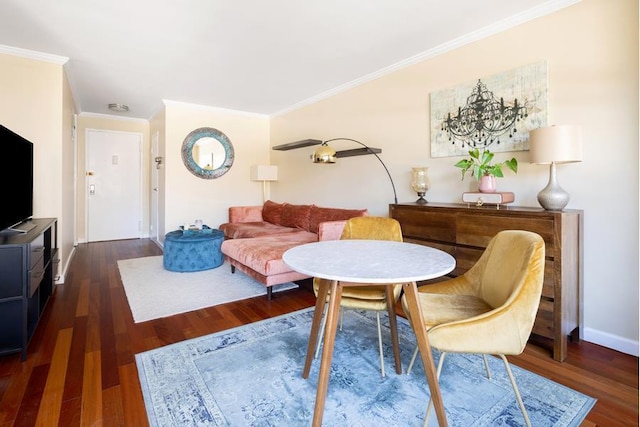 living area with ornamental molding, wood finished floors, and baseboards