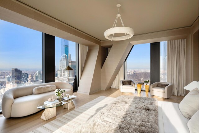 living room featuring floor to ceiling windows, a wealth of natural light, and light hardwood / wood-style flooring