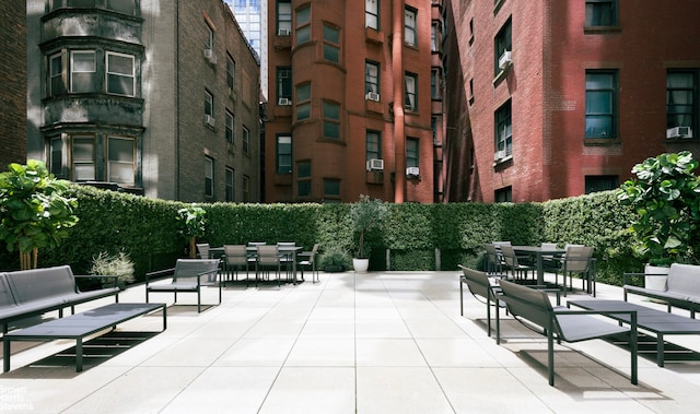 view of home's community featuring outdoor dining space and a patio