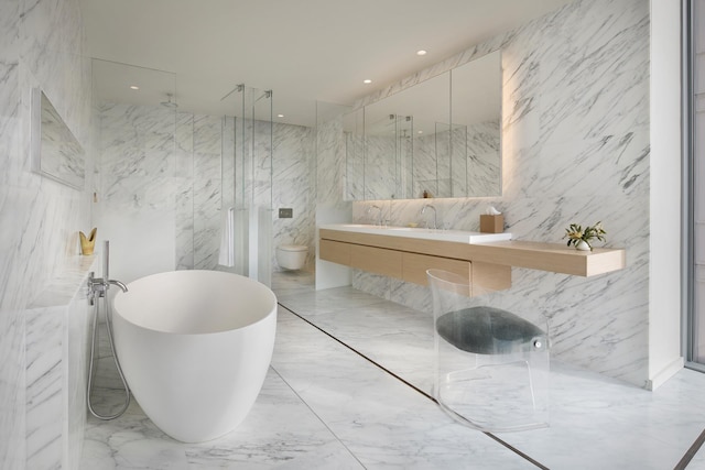 bathroom with marble finish floor, a marble finish shower, tile walls, a freestanding bath, and stone wall