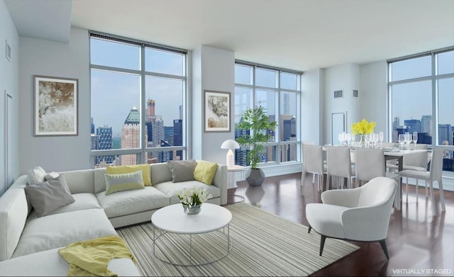 living area featuring a view of city, a healthy amount of sunlight, and floor to ceiling windows