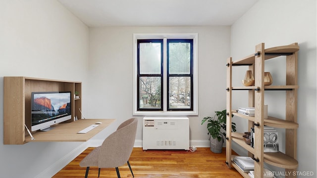 office space with baseboards and wood finished floors