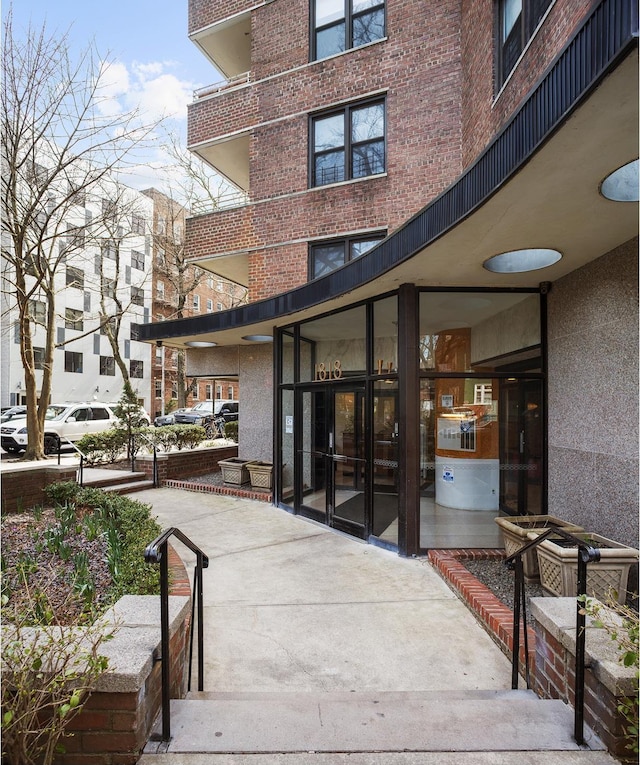 doorway to property with brick siding