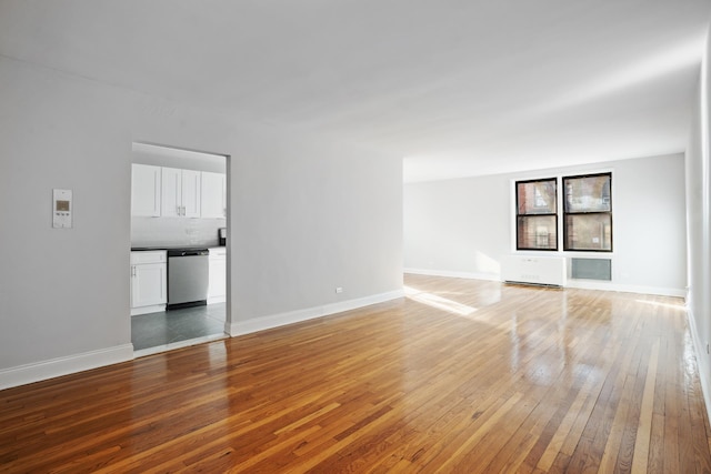 unfurnished living room featuring light wood finished floors and baseboards