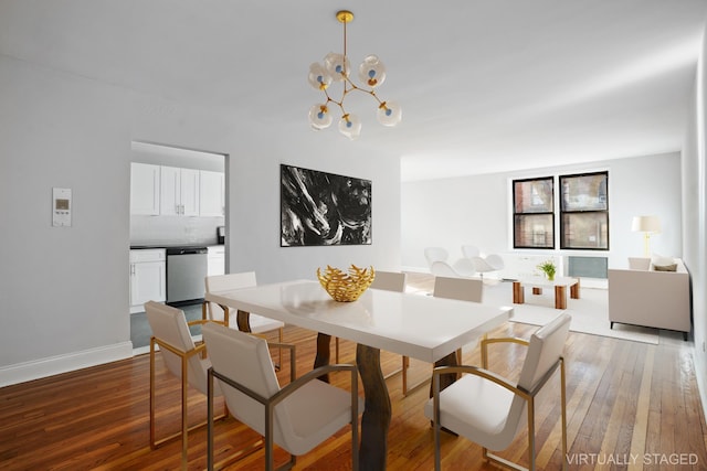 dining area with a notable chandelier, baseboards, and hardwood / wood-style flooring