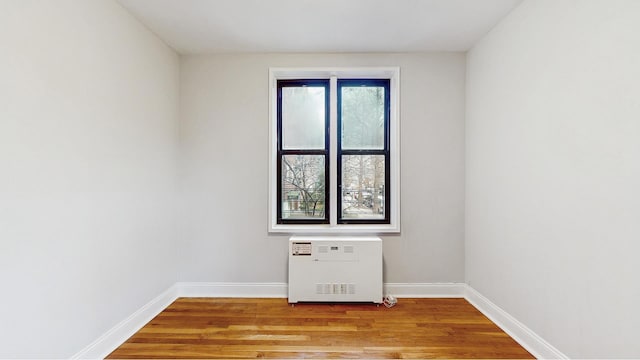 spare room with light wood-type flooring and baseboards