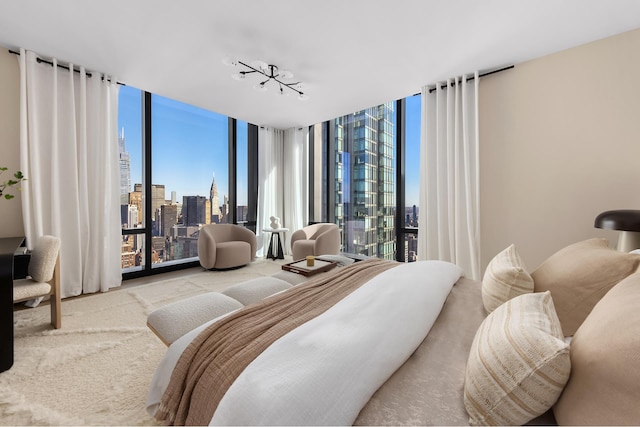 bedroom with a view of city, floor to ceiling windows, carpet flooring, and access to outside