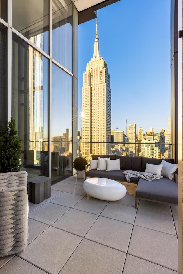 view of patio featuring an outdoor hangout area, a view of city, and a balcony