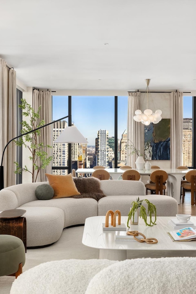 living room with floor to ceiling windows, a view of city, and a notable chandelier