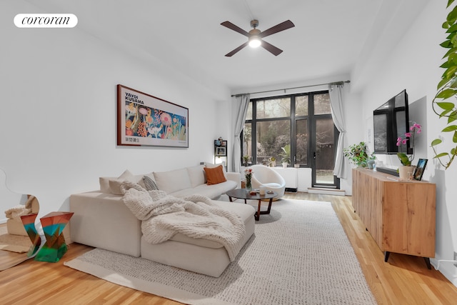 living area featuring ceiling fan, light wood-type flooring, and visible vents