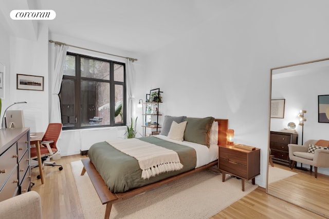 bedroom featuring visible vents and light wood-style flooring