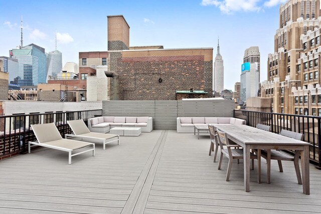 315 W 36th St Unit 12B, New York City, NY 10018 - wooden terrace with an outdoor hangout area, a skyline view, and outdoor dining area