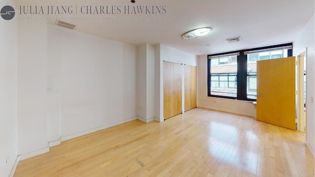 unfurnished bedroom featuring hardwood / wood-style floors and a closet