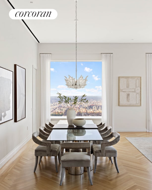 dining space with parquet floors and a healthy amount of sunlight