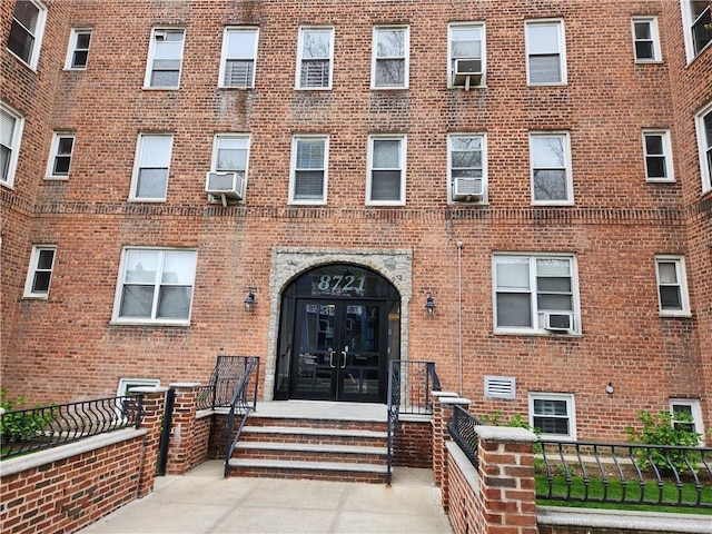 view of exterior entry featuring cooling unit and french doors