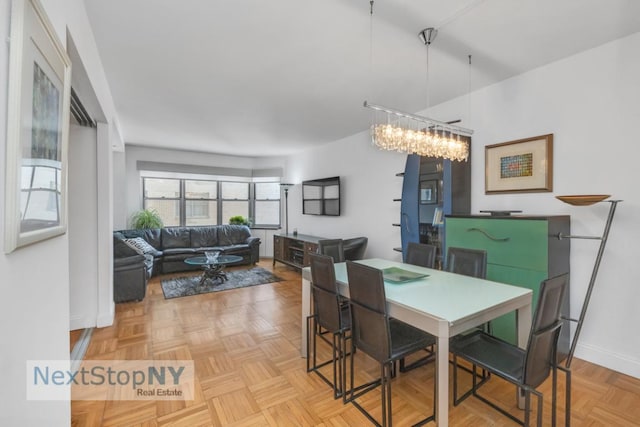 dining area featuring light parquet floors