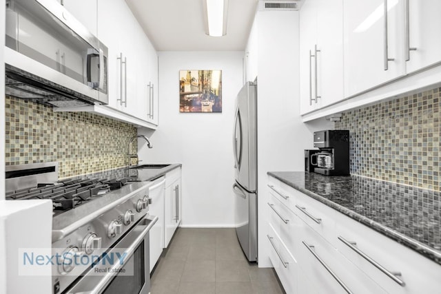 kitchen with sink, stainless steel appliances, and white cabinets