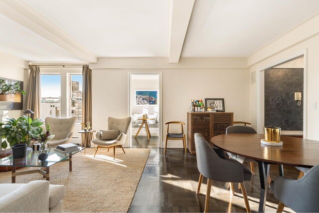 dining space with dark hardwood / wood-style floors and beam ceiling