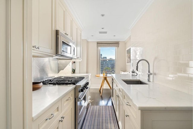 kitchen with appliances with stainless steel finishes, sink, tasteful backsplash, light stone counters, and ornamental molding