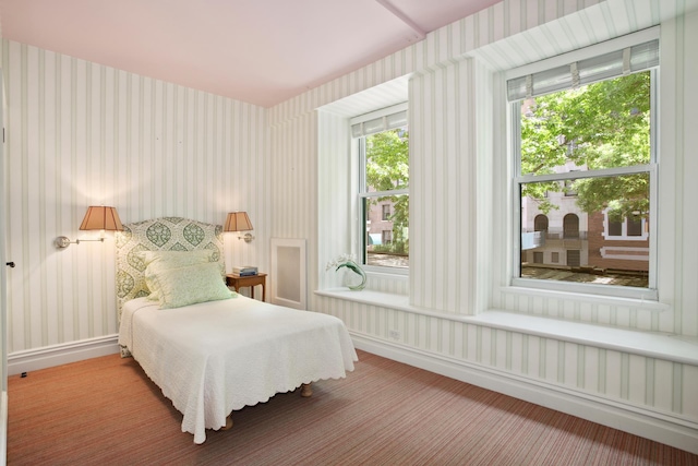 bedroom with baseboards and wallpapered walls