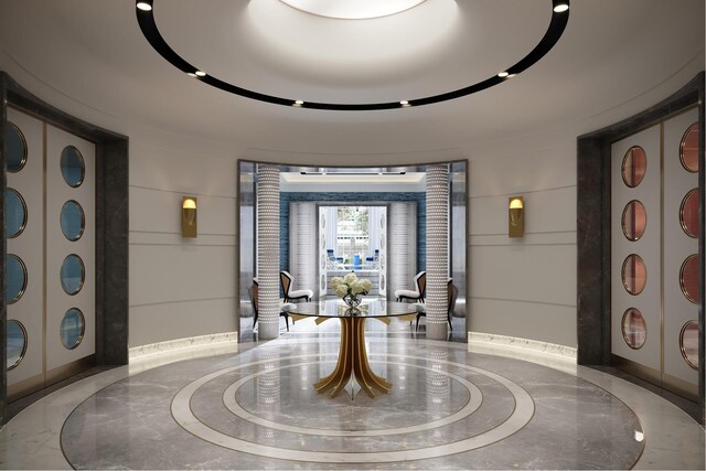 entrance foyer featuring marble finish floor and ornate columns