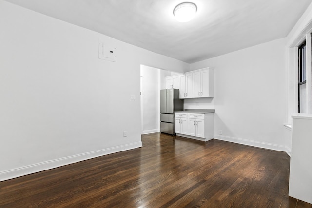 interior space with baseboards and dark wood finished floors