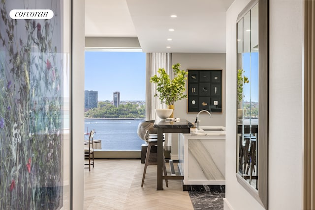 interior space with recessed lighting and a water view
